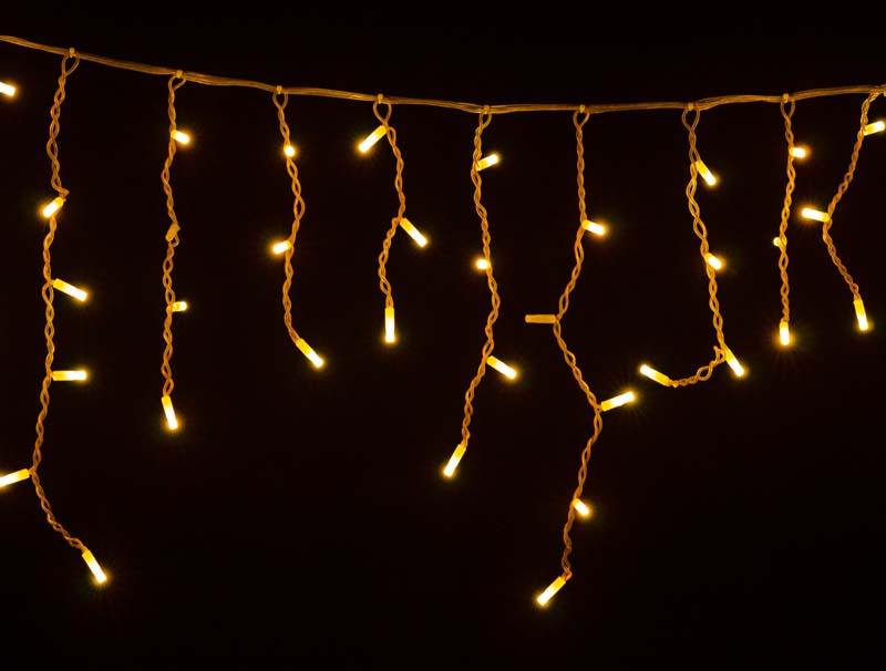 Colored glowing garland on black background Colored Christmas garlands on black background