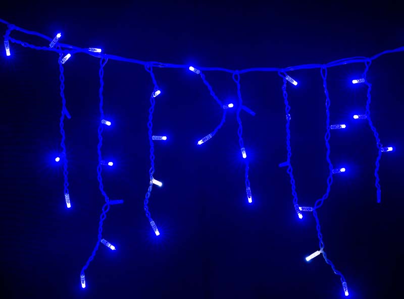 Colored glowing garland on black background Colored Christmas garlands on black background